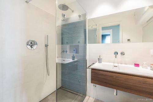 a bathroom with a shower and a sink at Draisina Bike Apartments DUE in Oleggio Castello