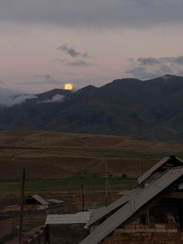 a view of the sun rising over the mountains at Guest House Bektash in Kyzart