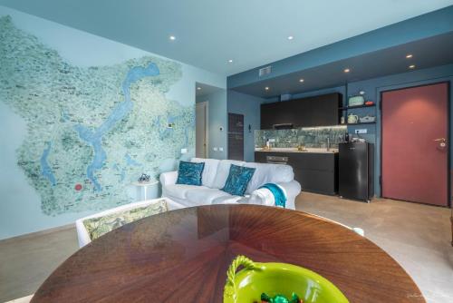 a living room with a table and a map on the wall at Draisina Bike Apartments DUE in Oleggio Castello