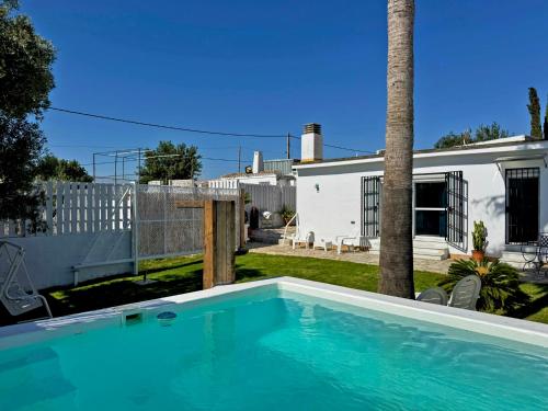 a swimming pool in front of a house at Casa Las Cumbres I - Ole Solutions in El Puerto de Santa María