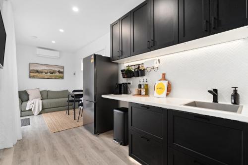a kitchen with black cabinets and a counter top at Hollow Mountain Cabin Laharum Dadswell Bridge in Laharum