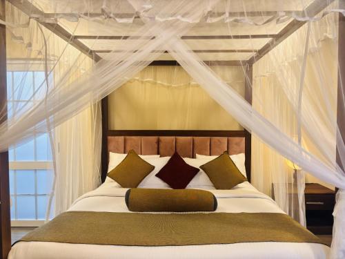a bedroom with a bed with a canopy at Hill Cool Hotel & Restaurant in Hatton