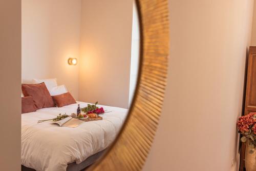 a bedroom with a bed and a mirror at Maison Gabrielle in Vals-les-Bains