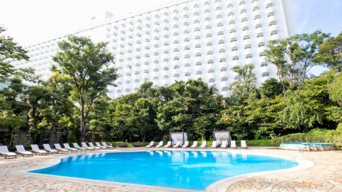 a swimming pool in front of a building at Takanawa Hanakohro - in Grand Prince Hotel Takanawa in Tokyo