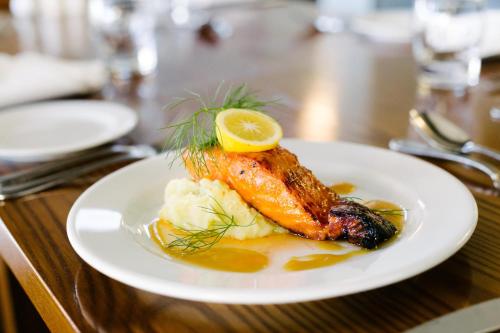 a plate of food with a piece of fish on a table at Hotel Ashburton in Ashburton