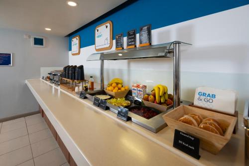 a food counter in a store with fruit and bread at Holiday Inn Express Taunton East by IHG in Taunton