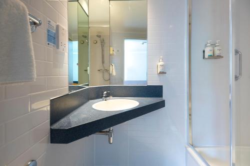 a bathroom with a sink and a mirror at Holiday Inn Express Taunton East by IHG in Taunton