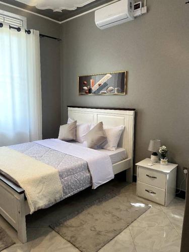 a bedroom with a large bed with white sheets and pillows at Haven Heights in Entebbe