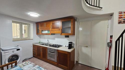 a kitchen with a sink and a stove top oven at Borgo di mare in Gaeta