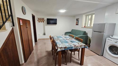 a kitchen with a table with chairs and a refrigerator at Borgo di mare in Gaeta