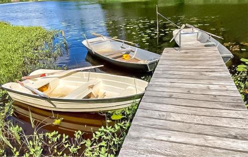 two boats are docked next to a wooden dock at Beautiful Apartment In Holmsjö With Wifi in Holmsjö