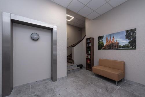 a waiting room with a chair and a painting on the wall at Vilnius City Hotel in Vilnius