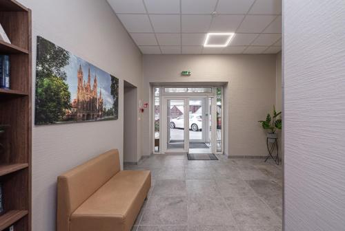 an office corridor with a couch in a hallway at Vilnius City Hotel in Vilnius