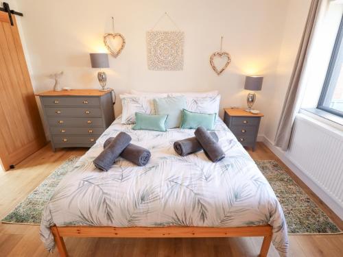 a bedroom with a bed with pillows on it at Sandy Toes in Mablethorpe