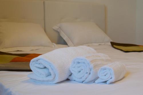 a pile of towels sitting on a bed at Villa Belvedere in Militello in Val di Catania