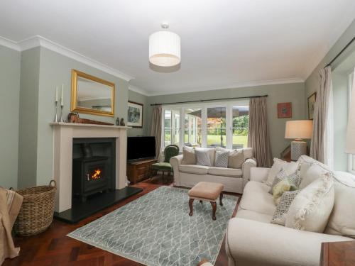 a living room with a couch and a fireplace at St Mary's House in Chipping Norton