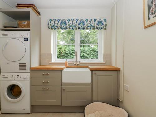a kitchen with a sink and a window at St Mary's House in Chipping Norton