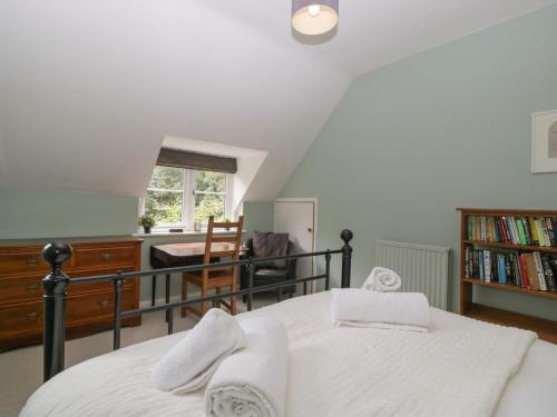 a bedroom with a bed and a staircase with a window at St Mary's House in Chipping Norton