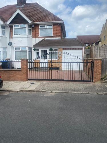 a black fence in front of a house at OneDouble room, one small double room, one en-suite studio room near to Wembley stadium in London