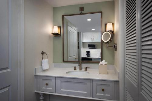 a bathroom with a sink and a mirror at Disney's Saratoga Springs Resort & Spa in Orlando