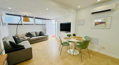 a living room with a table and a couch at Bungalow Mesana 27 in Playa Honda