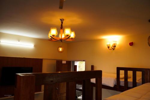 a bedroom with a bed and a chandelier at 11 Haven Street Kodaikanal in Kodaikānāl