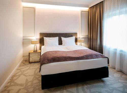 Katil atau katil-katil dalam bilik di ARCOTEL Castellani Salzburg