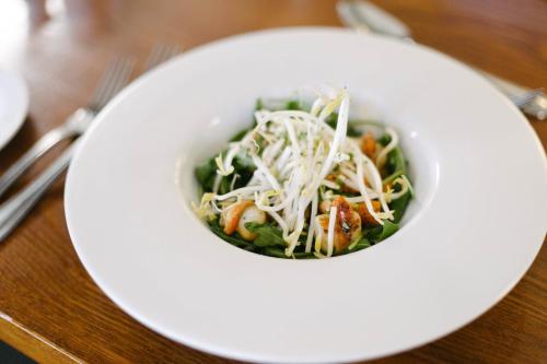 a bowl of food on a white plate on a table at Hotel Ashburton in Ashburton