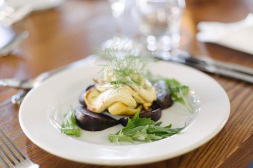 a plate of food on a wooden table at Hotel Ashburton in Ashburton