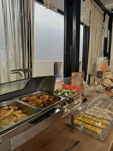a buffet with many different types of food on a table at Villa La Mer Durres in Durrës