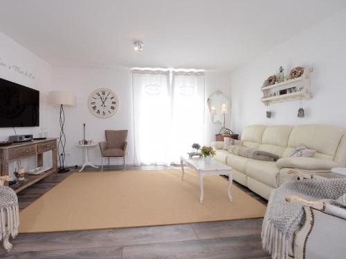 a living room with a couch and a table at Nausikaa's- Fleur de Lis in Groß Schwansee