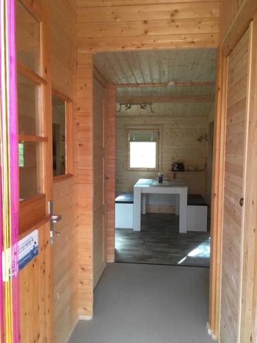 a small room with a table in a wooden cabin at Ferienbungalow Nautik in Hoppenwalde