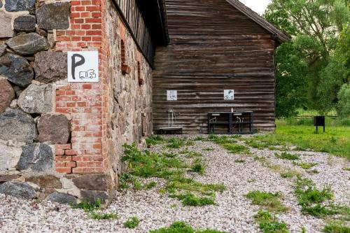 a brick building with a sign on the side of it at Glamping Szelągówka, Sun & Snow in Sorkwity