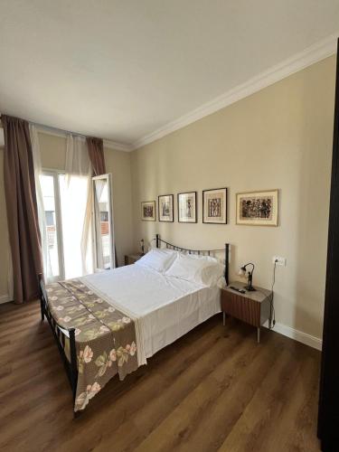 a bedroom with a bed and a large window at 5 Ragazze in Campofilone
