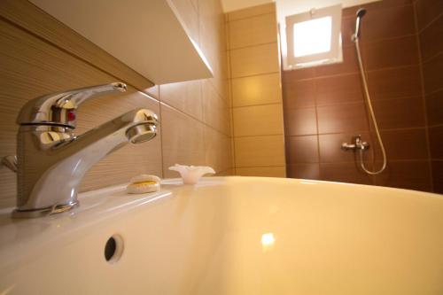 a bathroom with a sink and a faucet at Falassarna Beach studios&apartments in Falasarna