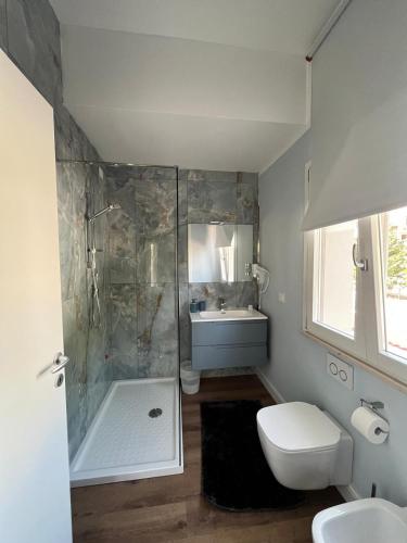 a bathroom with a shower and a toilet and a sink at 5 Ragazze in Campofilone