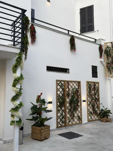 a white building with plants on the wall at Dimora Luminè in Naples