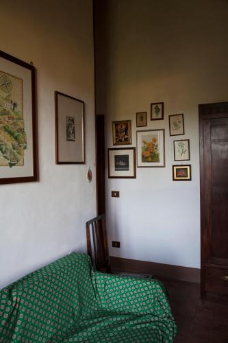 a bedroom with a bed and pictures on the wall at Agriturismo Santa Maria in Torrita di Siena