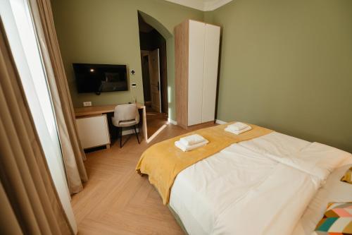 a bedroom with a bed with two towels on it at Villa Botar in Cluj-Napoca