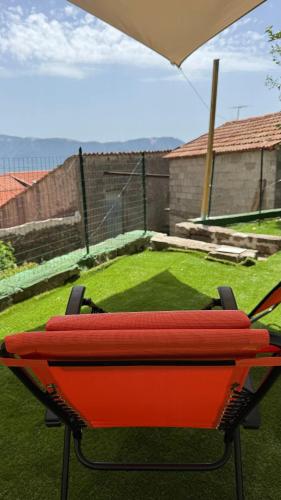 a table with two redairs on it in a backyard at Bella casa nel cuore del Cilento in Montano Antilia