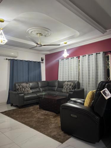 a living room with a couch and a ceiling at Serene 2 bedroom fully furnished house in Haatso