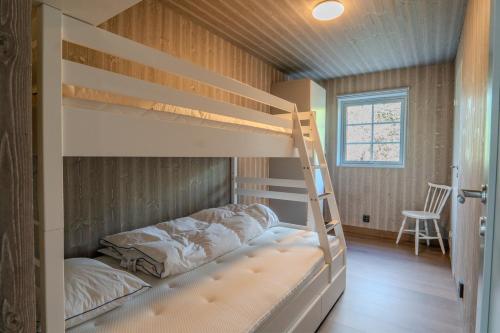 a bunk bed in a room with a bunk bed in a house at Newly built house | Sauna | EV charger | Terrace in Lofsdalen