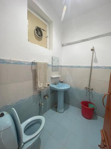 a bathroom with a toilet and a sink at lake view hotel and resort in Khānpur