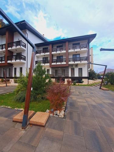 a large apartment building with a pole in front of it at Piatra Pinului Ski & Spa in Gura Humorului
