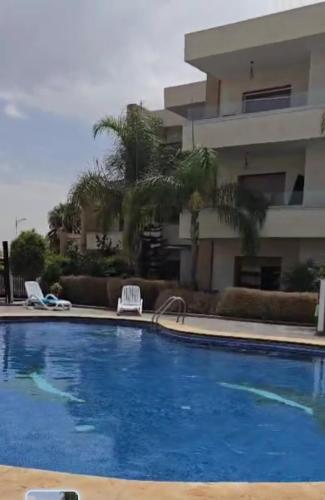 a large swimming pool in front of a building at Appartement de luxe, Résidence Tamaris Marina in Saidia 