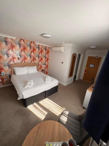 a hotel room with a bed and a wall at Best Western Andover in Andover
