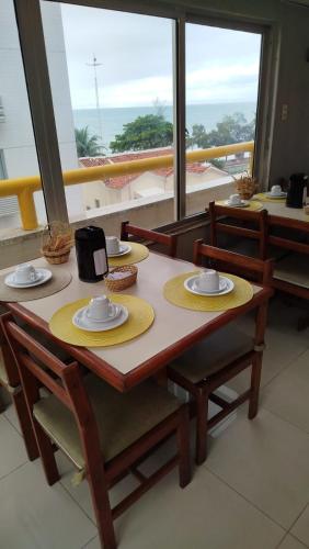 a table with plates and napkins on top of it at Villa Mar Boa Viagem in Recife