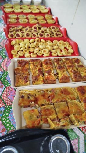 three trays of food sitting on a table at Villa Mar Boa Viagem in Recife