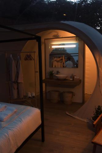 a bedroom with a bed and a mirror in a room at El Nido Frigiliana in Frigiliana
