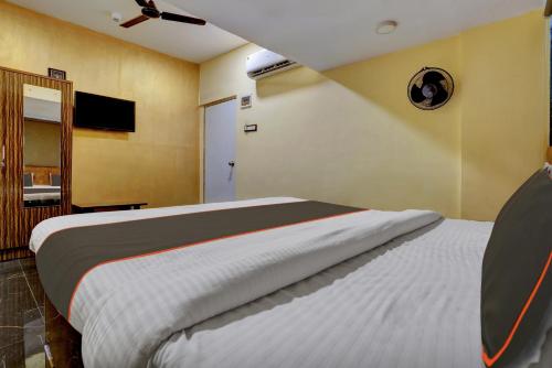 a bedroom with a bed and a television in it at Super Hotel O Golden Suites in Turambhe